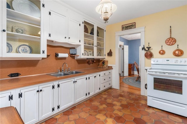 35 Miles Ave, East Providence, RI 02914 - kitchen featuring white electric range, a sink, white cabinets, glass insert cabinets, and a wainscoted wall