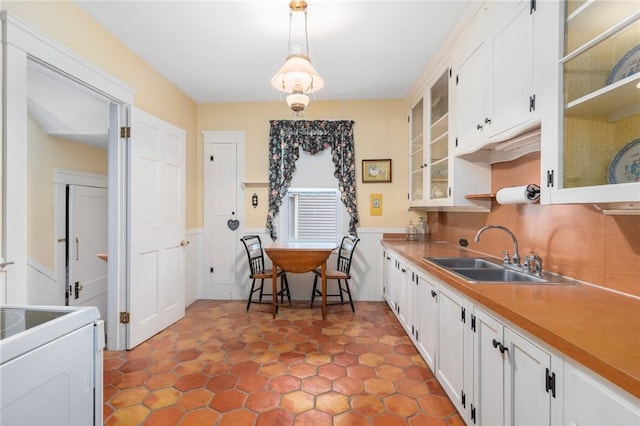 35 Miles Ave, East Providence, RI 02914 - kitchen with a sink, white cabinets, pendant lighting, range, and wainscoting