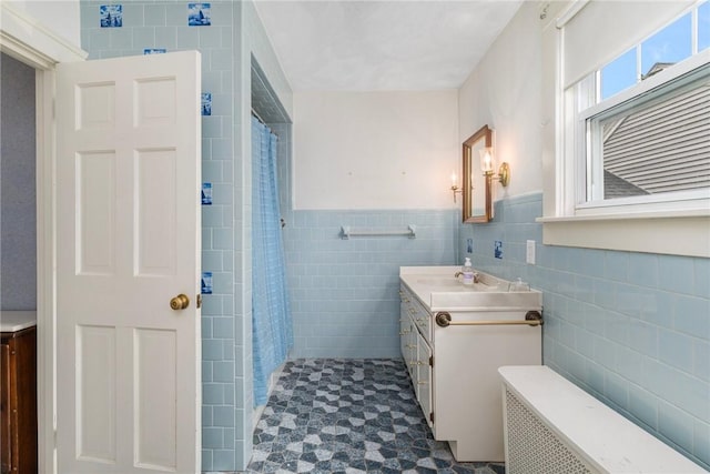 35 Miles Ave, East Providence, RI 02914 - bathroom featuring tile walls, vanity, radiator heating unit, a shower with curtain, and wainscoting
