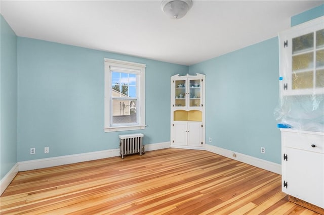 35 Miles Ave, East Providence, RI 02914 - empty room with radiator, light wood-type flooring, and baseboards