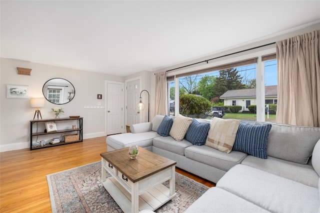 living room with light wood-type flooring and baseboards