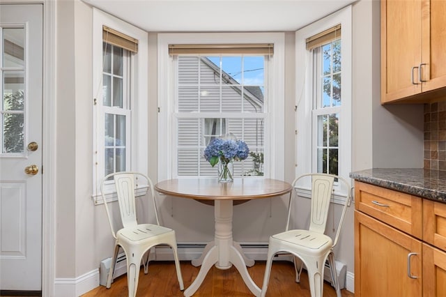 dining room with light wood finished floors and baseboards