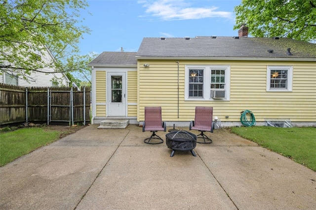 rear view of property with a patio, fence, an outdoor fire pit, and a chimney