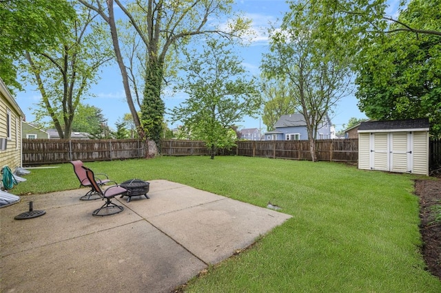view of yard with a storage shed, a patio, a fire pit, and an outdoor structure