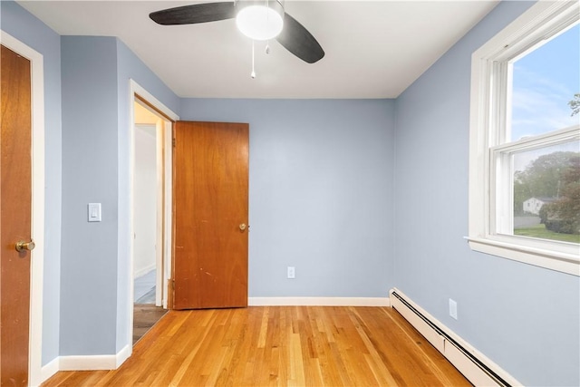 3 Baylor Dr, Coventry, RI 02816 - unfurnished room with baseboard heating, light wood-style flooring, a ceiling fan, and baseboards