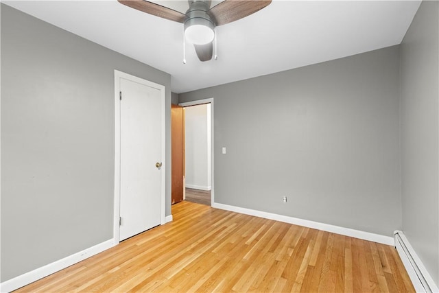 3 Baylor Dr, Coventry, RI 02816 - unfurnished room featuring baseboard heating, baseboards, wood finished floors, and ceiling fan
