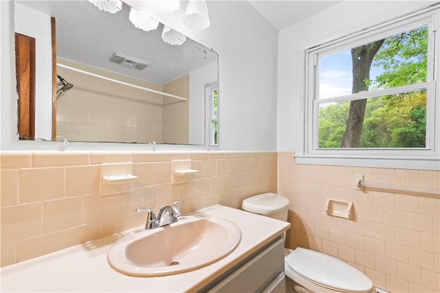 3 Baylor Dr, Coventry, RI 02816 - bathroom featuring toilet, tile walls, vanity, a shower, and a wainscoted wall