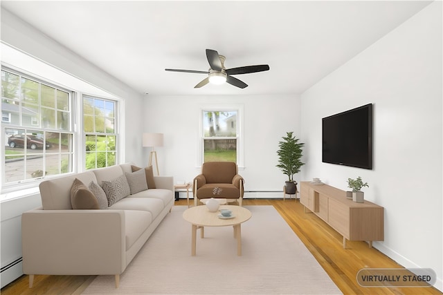 3 Baylor Dr, Coventry, RI 02816 - living area featuring light wood finished floors, baseboard heating, and a ceiling fan