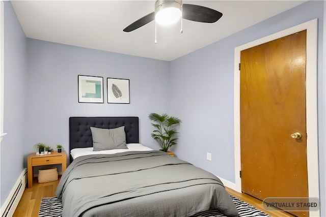 3 Baylor Dr, Coventry, RI 02816 - bedroom with a baseboard heating unit, wood finished floors, baseboards, and ceiling fan