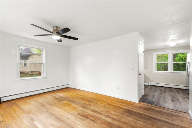 3 Baylor Dr, Coventry, RI 02816 - empty room with a baseboard heating unit, baseboard heating, wood finished floors, baseboards, and a ceiling fan