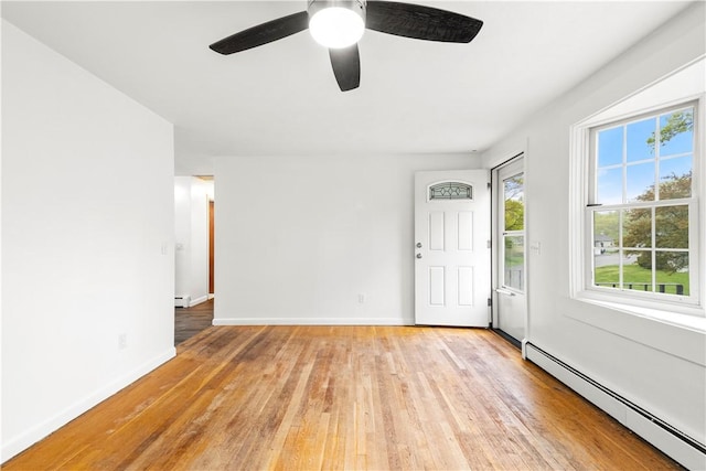 3 Baylor Dr, Coventry, RI 02816 - entrance foyer featuring a baseboard heating unit, baseboards, plenty of natural light, and light wood finished floors