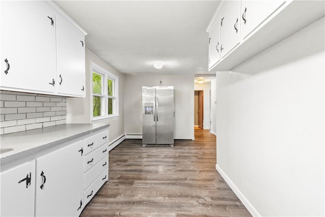 3 Baylor Dr, Coventry, RI 02816 - kitchen featuring stainless steel refrigerator with ice dispenser, light countertops, tasteful backsplash, white cabinets, and wood finished floors