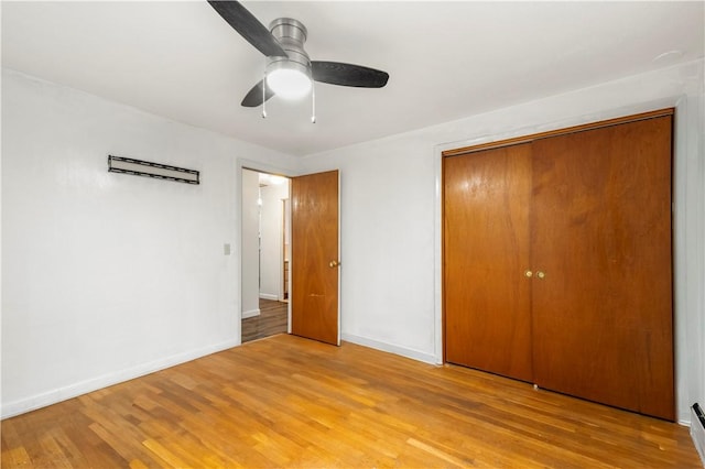 3 Baylor Dr, Coventry, RI 02816 - unfurnished bedroom featuring light wood finished floors, a closet, baseboards, and a ceiling fan