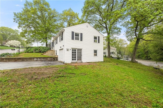 3 Baylor Dr, Coventry, RI 02816 - back of house featuring driveway, a garage, and a yard