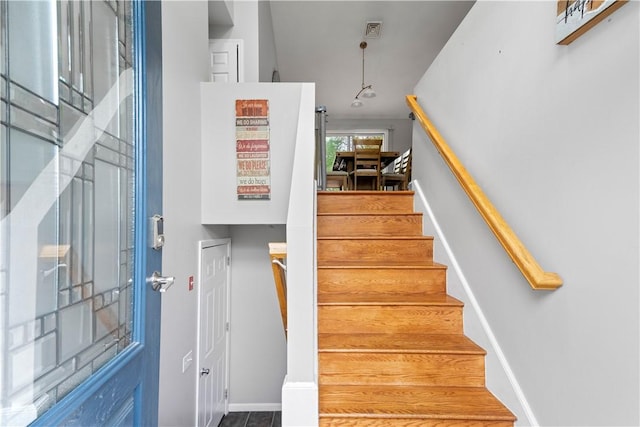 staircase featuring baseboards