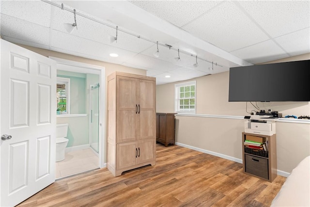 interior space featuring light wood-style flooring, baseboards, track lighting, and recessed lighting