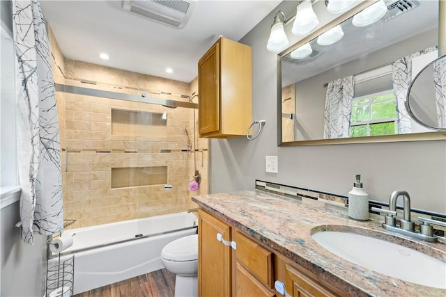 full bathroom with wood finished floors, toilet,  shower combination, vanity, and recessed lighting