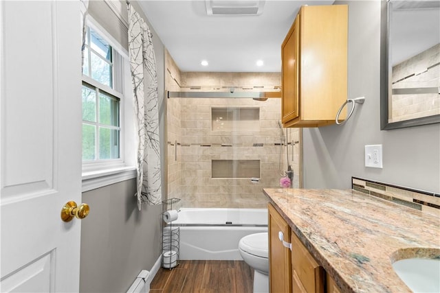 full bath with wood finished floors, toilet, vanity, combined bath / shower with glass door, and baseboards