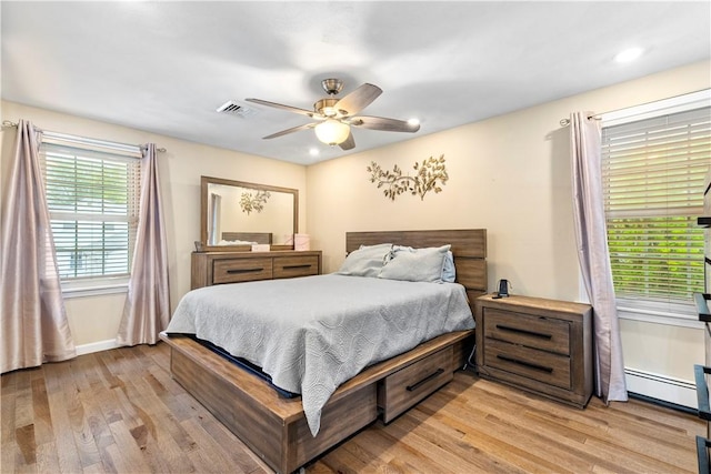 bedroom with a baseboard radiator, light wood-style flooring, a ceiling fan, recessed lighting, and baseboards