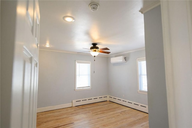 unfurnished room with a wall mounted AC, crown molding, a baseboard radiator, ceiling fan, and light wood finished floors