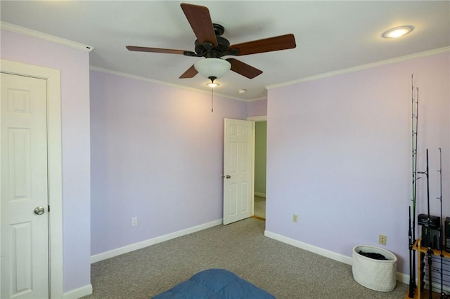 unfurnished bedroom with carpet flooring, baseboards, crown molding, and ceiling fan