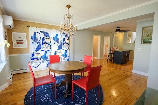 dining area with a baseboard heating unit, light wood-type flooring, a chandelier, baseboards, and ornamental molding
