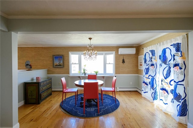 dining room with a baseboard radiator, hardwood / wood-style flooring, a wall mounted AC, and a chandelier
