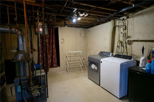 unfinished below grade area featuring independent washer and dryer