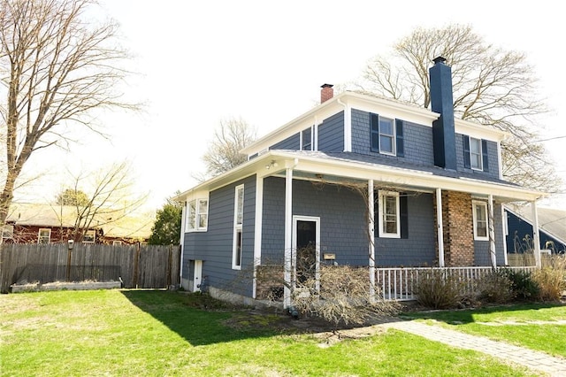 view of home's exterior with covered porch and a chimney