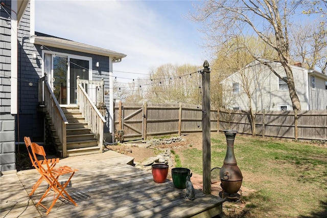 view of yard featuring a wooden deck and a gate