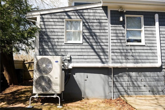 view of side of home featuring fence
