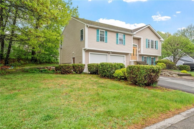 bi-level home with a garage and a front lawn