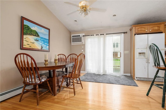 dining space featuring light wood-style flooring, lofted ceiling, an AC wall unit, a baseboard heating unit, and ceiling fan