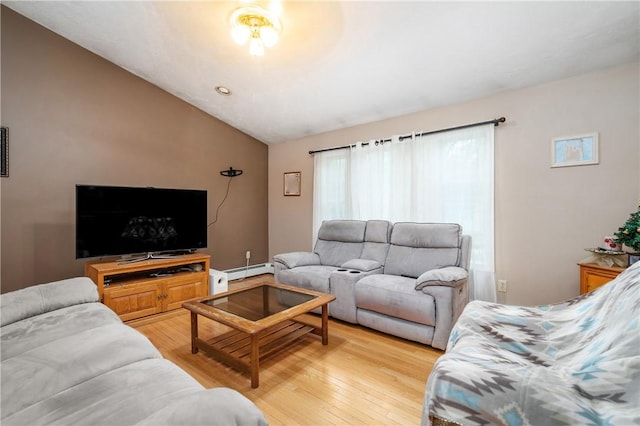 living area featuring a baseboard radiator, vaulted ceiling, and light wood-style flooring