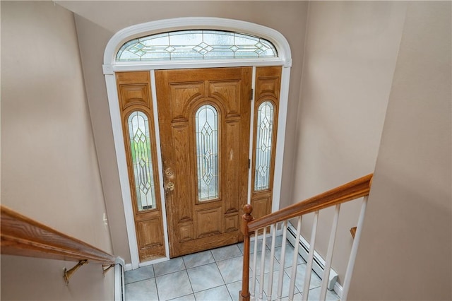 foyer with light tile patterned floors, baseboards, and stairway
