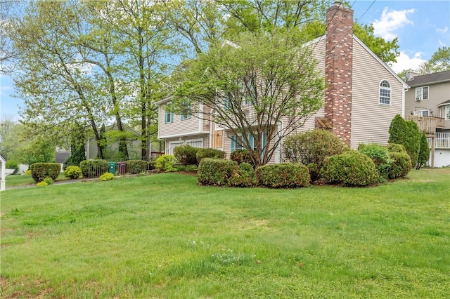 view of property exterior with a chimney, a garage, and a yard
