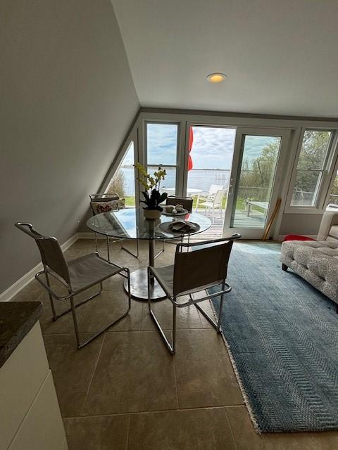 dining space featuring recessed lighting, baseboards, and dark tile patterned floors
