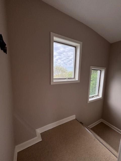 empty room featuring carpet floors and baseboards