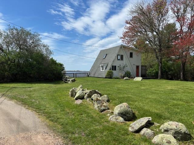 view of side of property featuring a yard and a garage