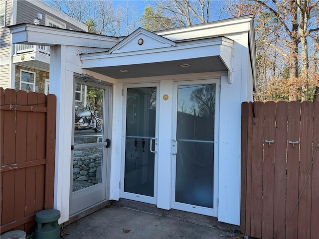 entrance to property featuring fence