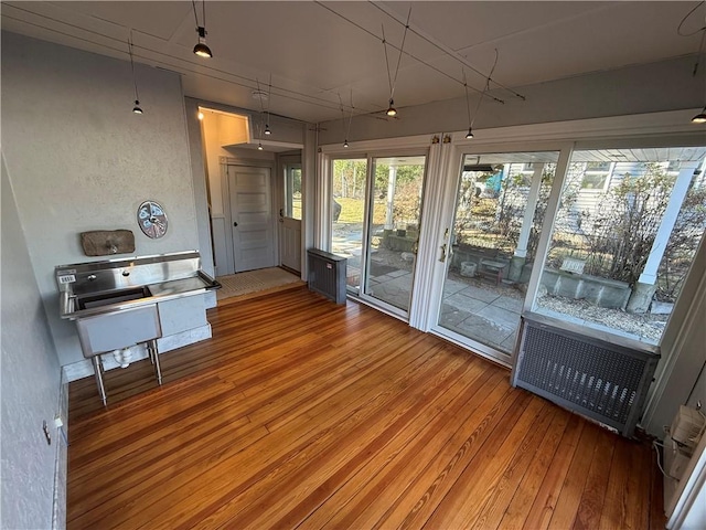 sunroom / solarium featuring radiator heating unit