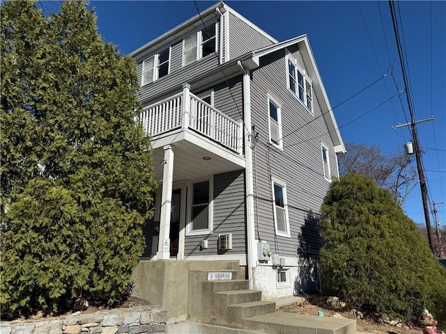 view of side of property with a balcony