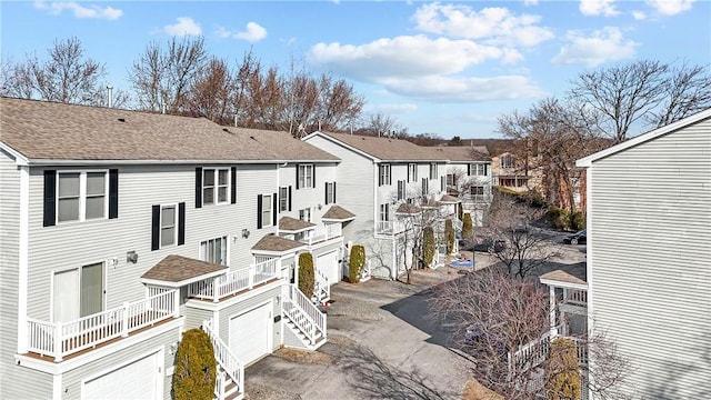 5 Morrill Ln Unit G, North Providence, RI 02904 - view of home's exterior featuring an attached garage, roof with shingles, a residential view, and a balcony