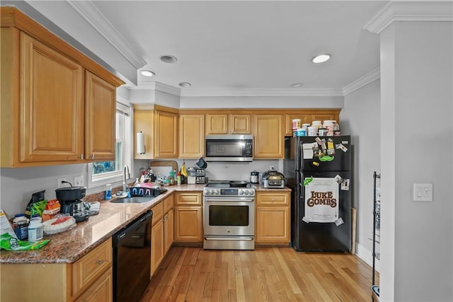 kitchen featuring black appliances, a sink, crown molding, light stone counters, and light wood-style flooring