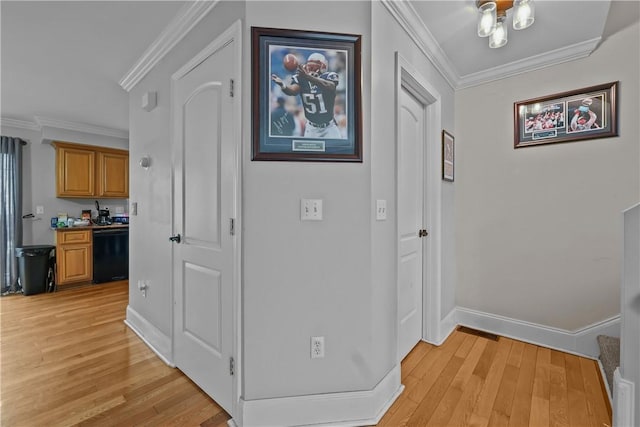 corridor with light wood-type flooring, baseboards, and crown molding