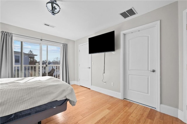 bedroom featuring baseboards and light wood finished floors