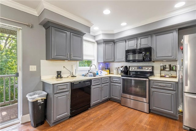 5 Morrill Ln Unit G, North Providence, RI 02904 - kitchen featuring black appliances, gray cabinets, light wood-style floors, healthy amount of natural light, and ornamental molding