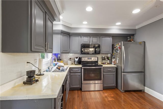 5 Morrill Ln Unit G, North Providence, RI 02904 - kitchen featuring stainless steel appliances, gray cabinetry, ornamental molding, dark wood-style flooring, and light countertops