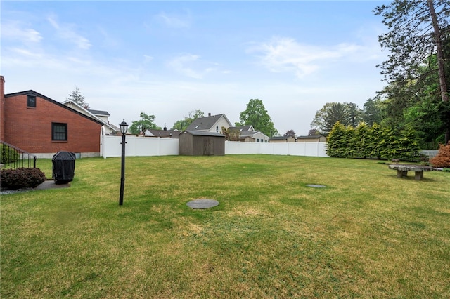 view of yard featuring a shed and an outbuilding