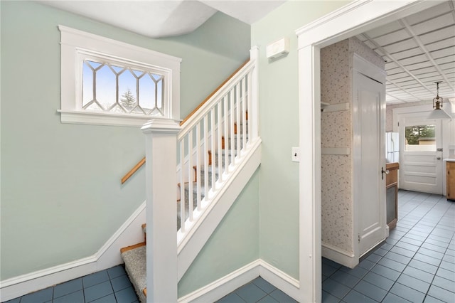 stairway with tile patterned flooring and baseboards